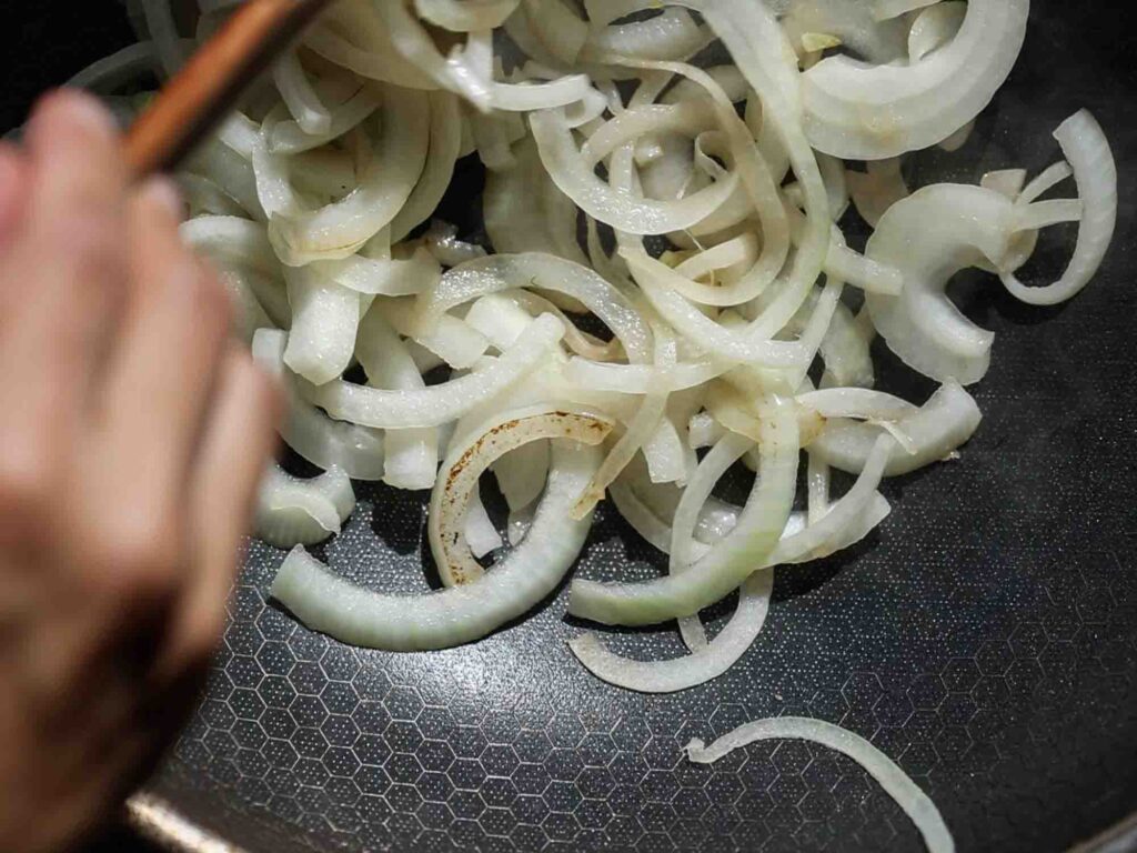 sauteeing onions in pan